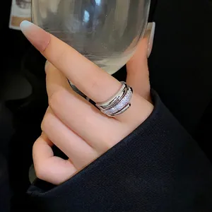 Elegant silver plated open ring with shimmering cubic zirconia stones shown on hand
