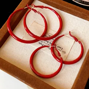 Vibrant red spray-painted minimalist hoop earrings for a bold retro jewelry statement