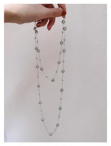 Detail shot of elegant long French vintage tiered necklace with polished silver beads