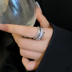 Close-up of elegant silver plated open ring with shimmering pave zircon details