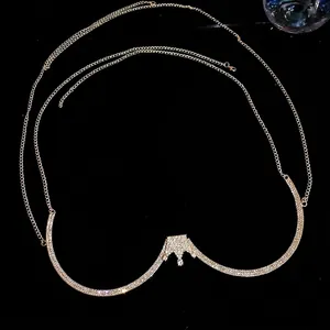 Elegant gold body chain with crown centerpiece and sparkling rhinestone inlay on black background