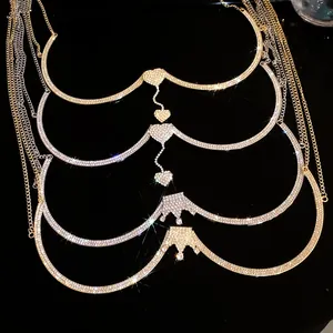 Macro detail of luxury rhinestone heart and crown body chains in gold and silver tones