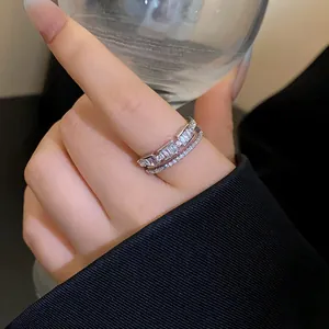 Detail view of an elegant double-layered silver-plated open ring with baguette zircons