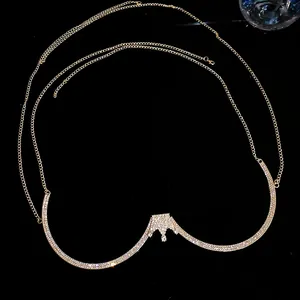 Detail of a luxurious golden rhinestone crown body chain jewelry on black background