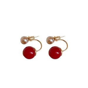 Elegant red and pearl bead C-shaped earrings with gold-tone finish for festive occasions.