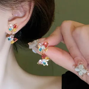 Close-up detail of colorful zircon butterfly earrings with sparkling multi-colored stones
