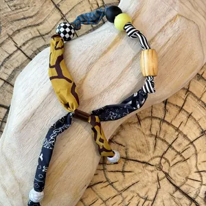 Close-up detail of ethnic style fabric necklace featuring diverse animal prints and beads