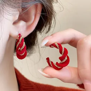 Elegant red velvet twisted hoop earrings with gold chain detail for Lunar New Year.