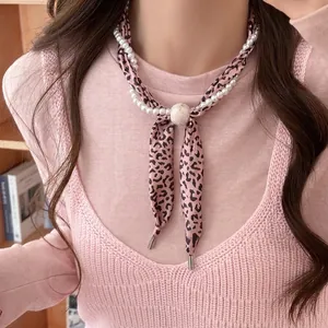 Pink leopard print fabric necklace with white pearls and marble bead detail
