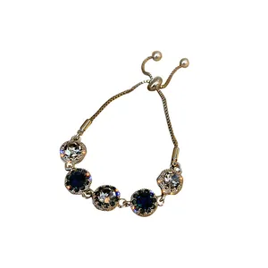 Elegant minimalist gold-plated adjustable bracelet with blue and clear sparkly crystals