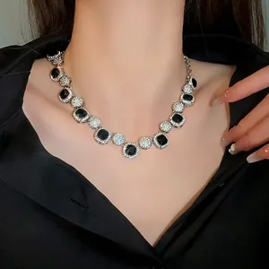 Elegant geometric choker necklace featuring black stones and sparkling rhinestones on model