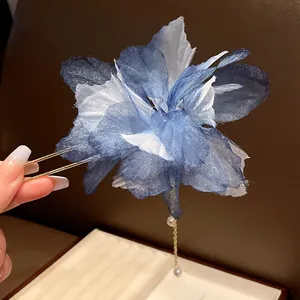 Close-up detail of blue chiffon flower hair pin with pearl tassel and U-shaped fork