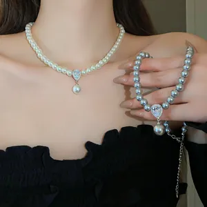 Close-up of elegant pearl necklace featuring a sparkling water drop zircon pendant