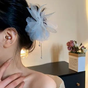 Close-up of light blue chiffon flower hairpin with elegant pearl tassel