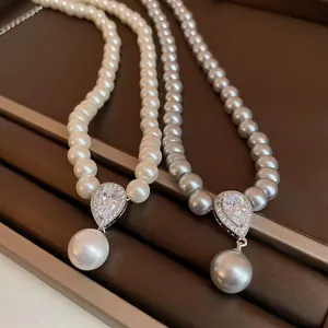 Detail shot of French vintage pearl necklaces with waterdrop zircon pendants in a tray.