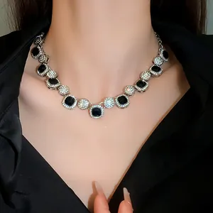 Detailed macro view showing the intricate design of black and silver gemstone necklace