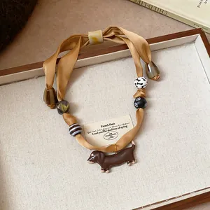 Ethnic handmade fabric cord necklace with cute brown acrylic dachshund dog pendant