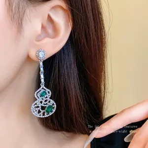 Elegant hollow gourd drop earrings with green gemstones and sparkling white rhinestones