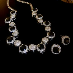 Close-up of elegant rhinestone necklace and earring set with black stones