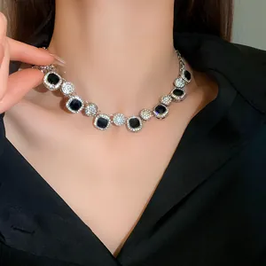 Close-up of geometric rhinestone choker necklace with black and clear stones on a model