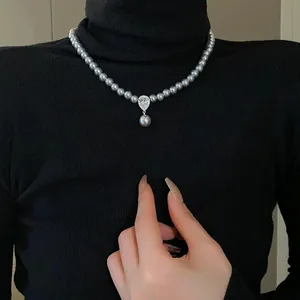 Elegant close-up of a French vintage gray pearl necklace with a pear-shaped zircon drop pendant.