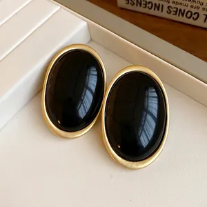 Vintage minimalist oval black resin earrings with gold metal frame and silver needles