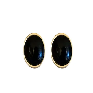 Elegant vintage oval black resin earrings with gold trim borders minimalist style