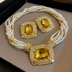 Elegant French palace style jewelry set with square yellow gemstones and multi-strand pearls