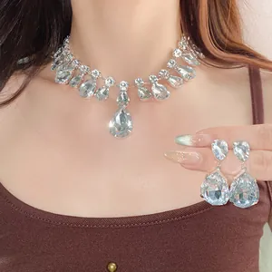 Exquisite detail view of sparkling silver-tone crystal teardrop necklace and earring set