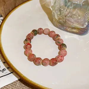 Close-up of New Chinese Style colorful cracked pattern glass bead bracelet on a plate