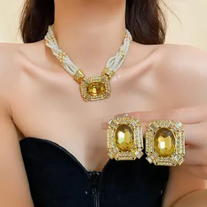 Detailed view of luxury French court style pearl necklace and amber gemstone earrings set