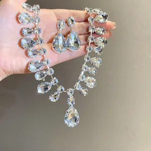 Close-up of sparkling teardrop crystal necklace and earrings jewelry set for women