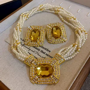 Detailed view of French vintage multi-strand pearl necklace with amber gemstone set
