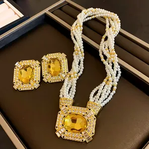 Close-up of vintage French square yellow gem pearl necklace and matching earring jewelry set.