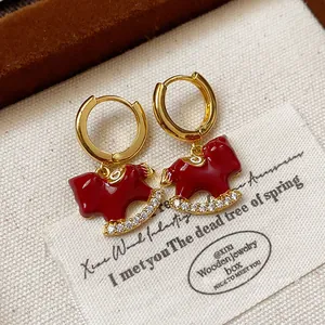 Red enamel rocking horse hoop earrings with gold plating and cubic zirconia details