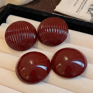 Vintage deep red semi-circular dome earrings with striped and smooth glossy texture