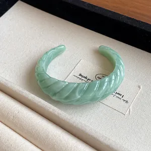 Elegant light green marbled resin open cuff bracelet with twisted geometric texture