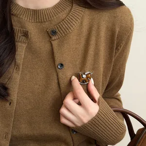 Elegant rhinestone horse brooch pin for women featured on brown autumn knitwear