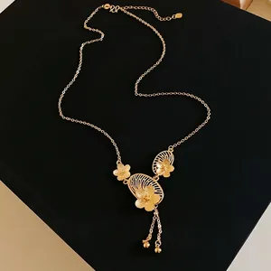 Elegant gold-plated Chinese style necklace with delicate flower charms and dainty tassels.