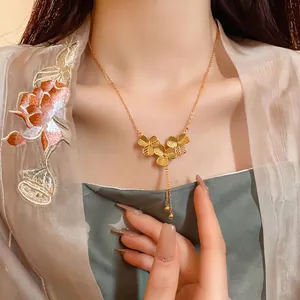 Elegant gold plated Chinese style necklace with flower charms and delicate tassels
