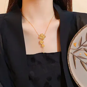 Elegant gold-plated Chinese style flower tassel necklace worn on a model.