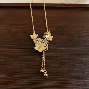 Detailed macro view of gold plated floral pendant with elegant tassel and filigree texture