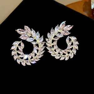 Detailed view of sparkling wheat ear earrings with pink marquise-cut stones