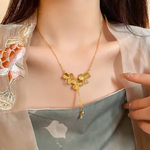 Elegant gold plated flower tassel necklace with Chinese style aesthetic on model