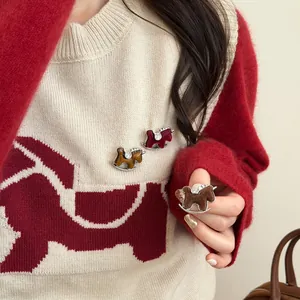 Detailed close-up of three colorful flocked rocking horse brooches with sparkling crystal accents