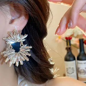 Close-up detail of elegant sparkly floral rhinestone earrings worn by an Asian model