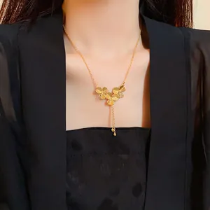 Close-up view of a luxury gold-plated flower necklace with delicate tassels on a model