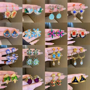 Close-up views showing a variety of colorful and artistic statement earring designs