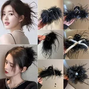 Detailed macro view of a stylish black feather hair claw clip for elegant updo hairstyles
