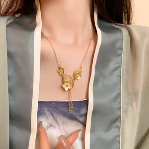 Close-up of elegant Chinese style gold-plated necklace with flower and tassel detail